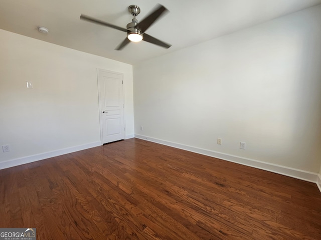 unfurnished room featuring ceiling fan, baseboards, and dark wood finished floors