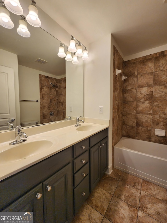 full bathroom featuring double vanity, visible vents, a sink, and shower / bathing tub combination