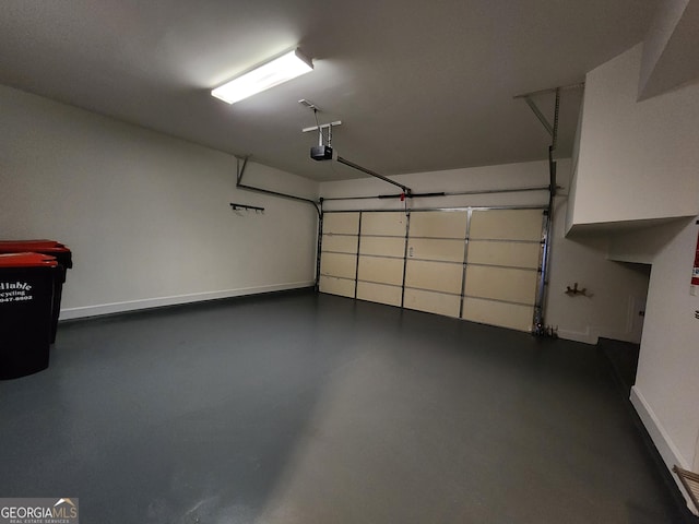 garage with baseboards and a garage door opener