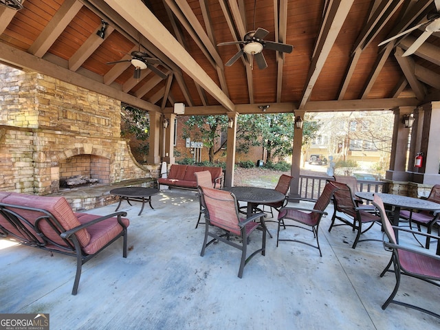 view of patio with outdoor dining area, ceiling fan, and a gazebo