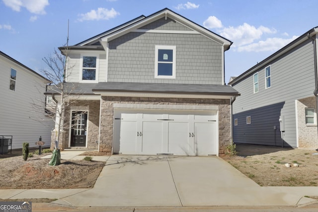 view of front of property with a garage, stone siding, and concrete driveway