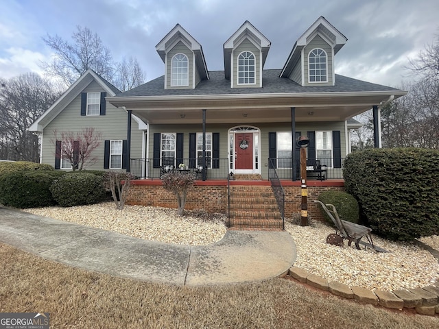 view of front of house with covered porch and roof with shingles