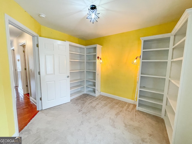 interior space featuring baseboards and carpet flooring