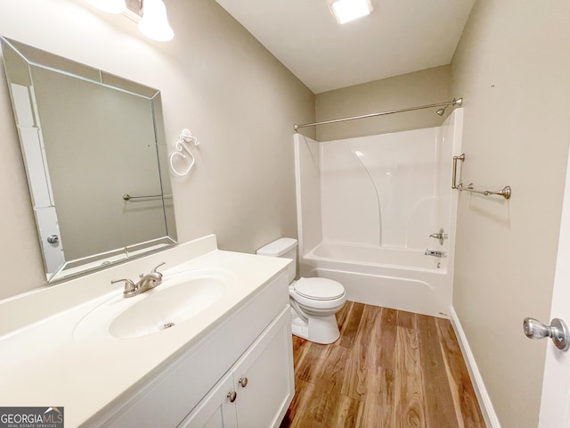 full bathroom featuring tub / shower combination, vanity, toilet, and wood finished floors