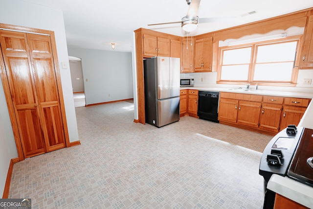 kitchen with light countertops, visible vents, ceiling fan, black appliances, and baseboards