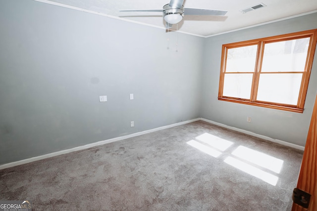 carpeted empty room featuring ornamental molding, visible vents, baseboards, and a ceiling fan