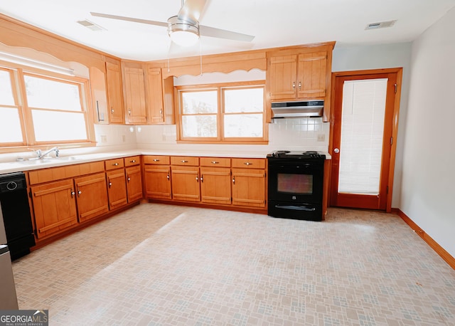 kitchen with under cabinet range hood, visible vents, light countertops, black appliances, and tasteful backsplash