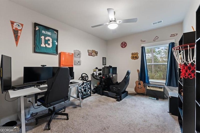 carpeted office featuring baseboards, visible vents, and a ceiling fan