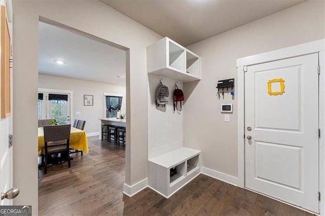 mudroom featuring dark wood-style flooring and baseboards