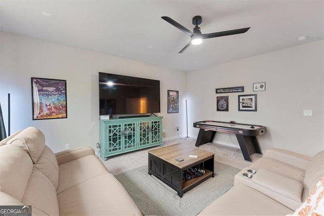 living area featuring carpet floors and ceiling fan