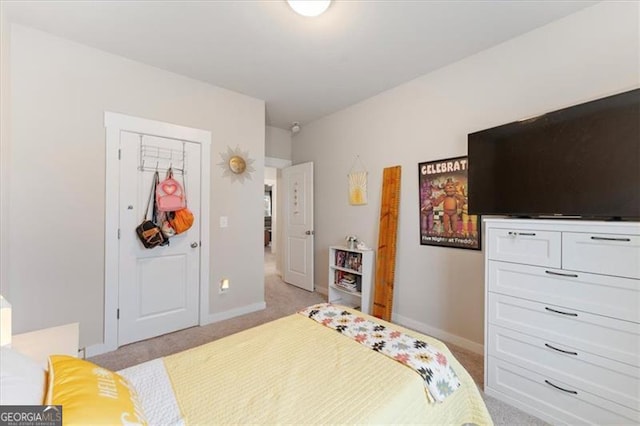 bedroom featuring baseboards and light colored carpet