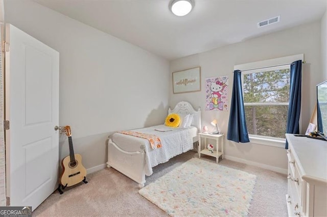 bedroom with light carpet, visible vents, and baseboards