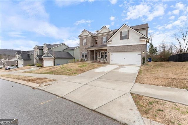 view of front of home featuring a front lawn, a residential view, driveway, and an attached garage