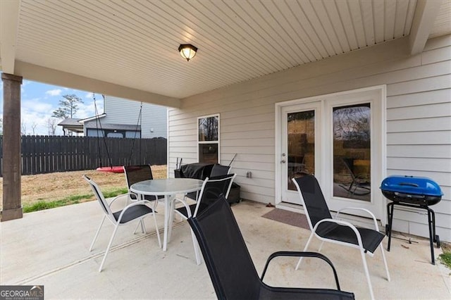 view of patio featuring fence, area for grilling, and outdoor dining space