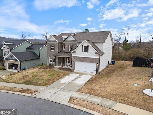 traditional-style home featuring a garage, concrete driveway, and a front yard