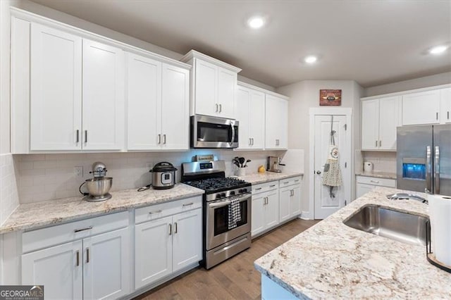 kitchen with white cabinetry, appliances with stainless steel finishes, and a sink