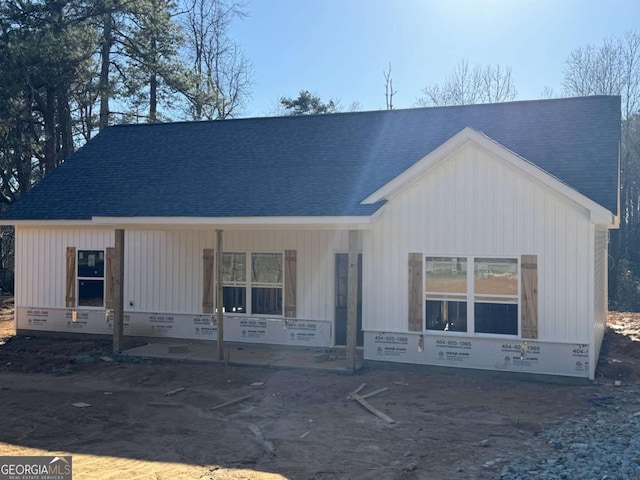 view of front of home featuring crawl space, covered porch, and roof with shingles