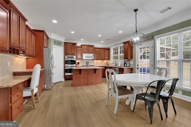 dining area featuring light wood-style flooring, visible vents, and recessed lighting