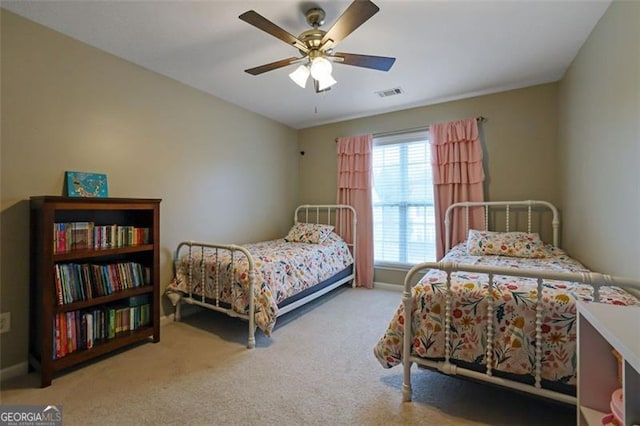 carpeted bedroom featuring visible vents and a ceiling fan