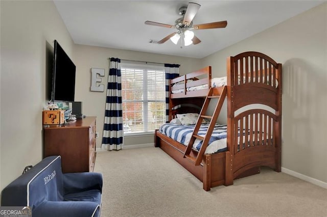 carpeted bedroom with ceiling fan and baseboards