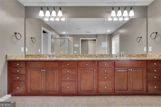 bathroom with a stall shower, tile patterned flooring, a sink, and double vanity