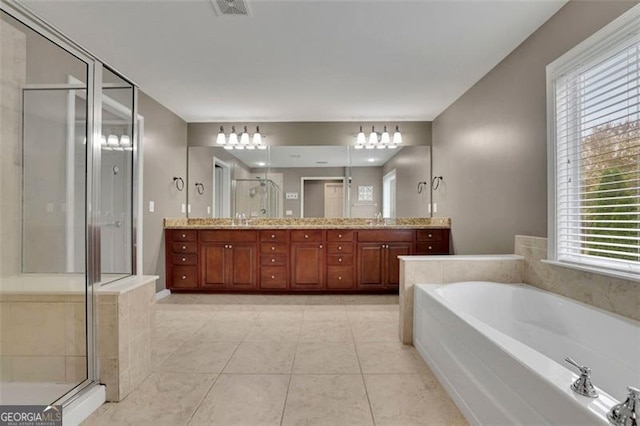 bathroom with a sink, visible vents, a shower stall, a bath, and double vanity