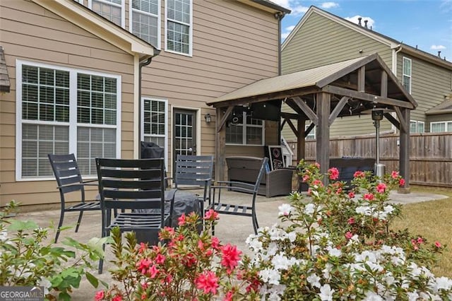 view of patio with fence and a gazebo