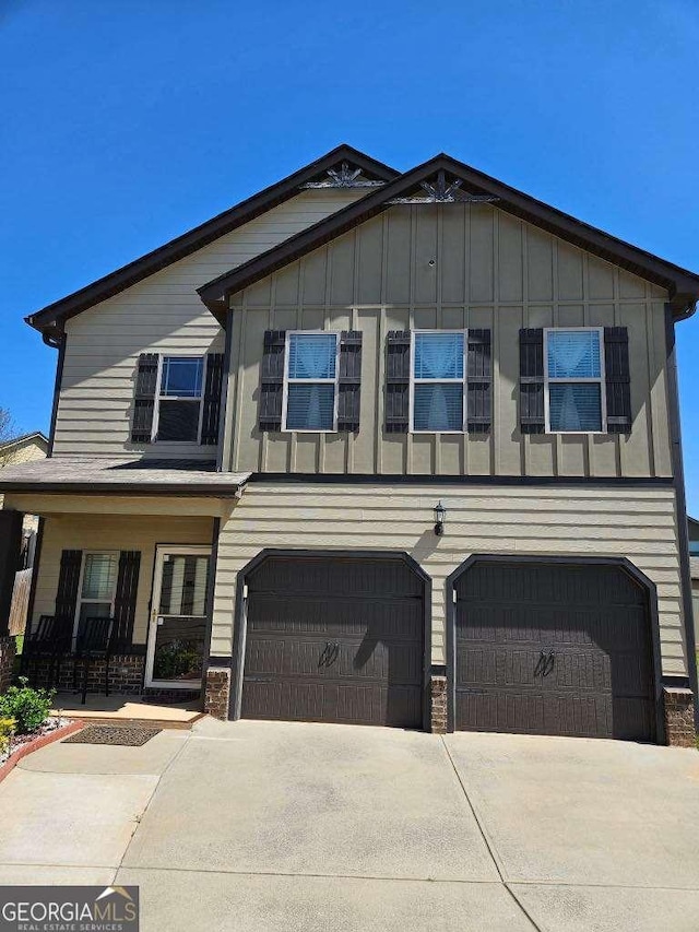 view of front of house with board and batten siding, concrete driveway, and an attached garage