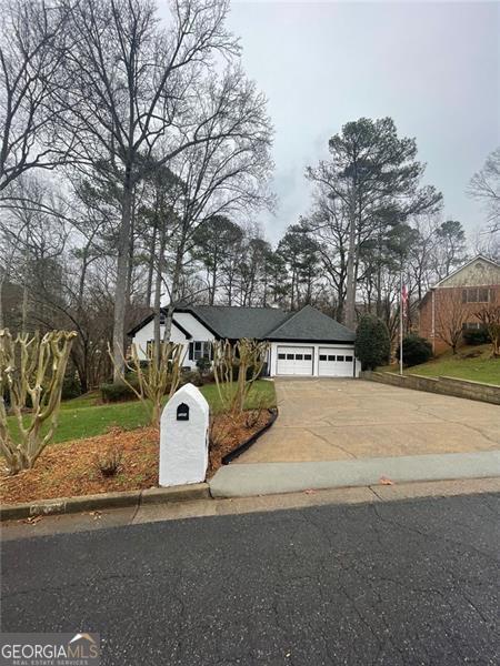 view of front of home with driveway and a garage