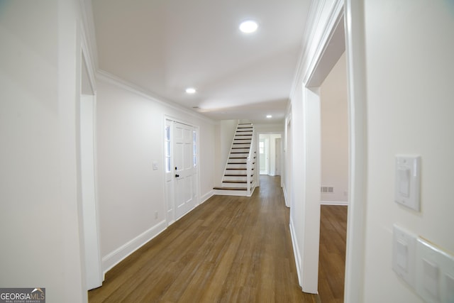 corridor featuring stairs, crown molding, recessed lighting, and wood finished floors
