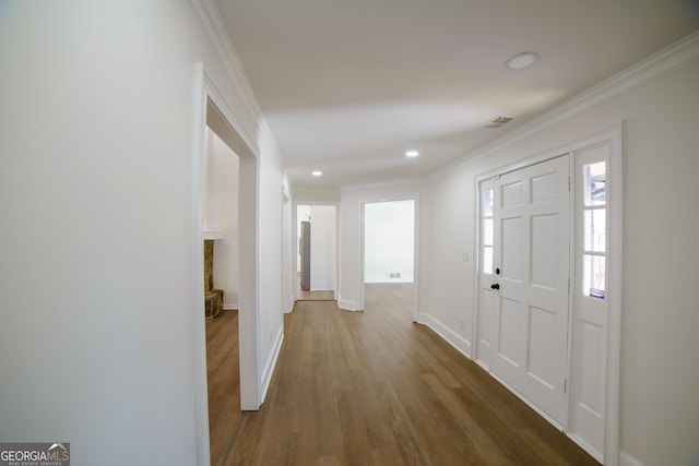 entrance foyer featuring recessed lighting, baseboards, wood finished floors, and crown molding