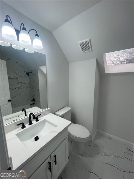 full bath featuring baseboards, visible vents, a shower, toilet, and marble finish floor