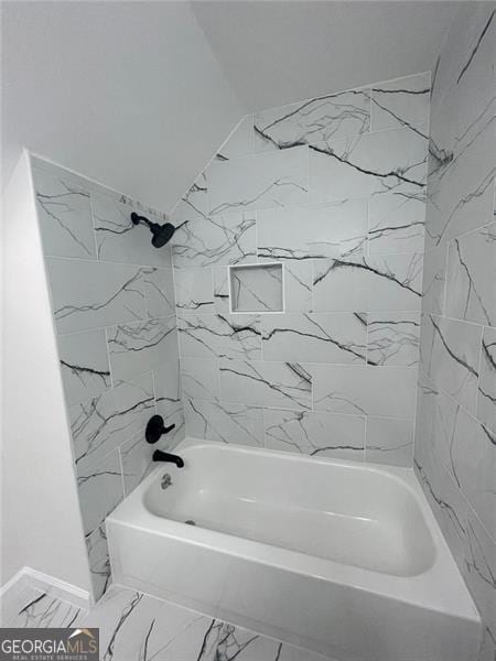 full bath with marble finish floor and  shower combination