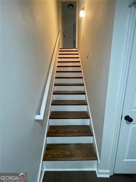 stairway featuring baseboards