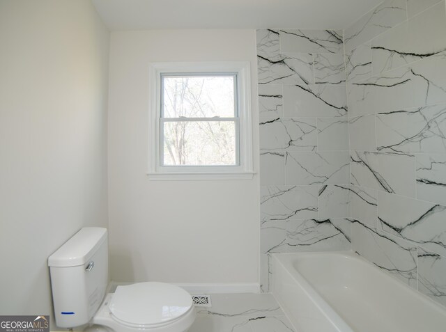 bathroom with shower / bathing tub combination, baseboards, toilet, and marble finish floor