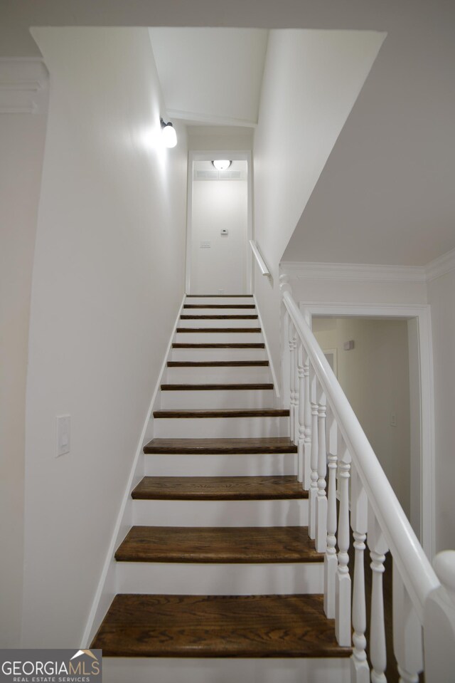 staircase with crown molding