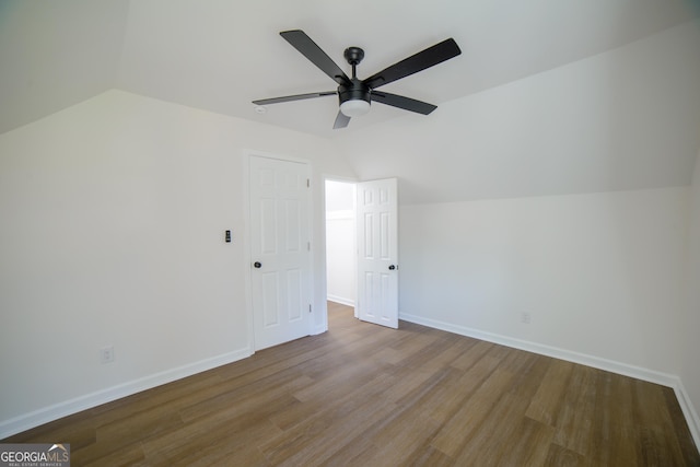 bonus room with ceiling fan, baseboards, lofted ceiling, and wood finished floors