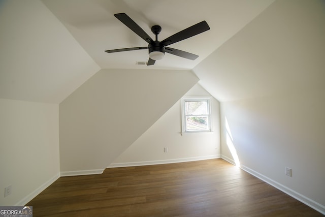 additional living space featuring vaulted ceiling, wood finished floors, baseboards, and visible vents