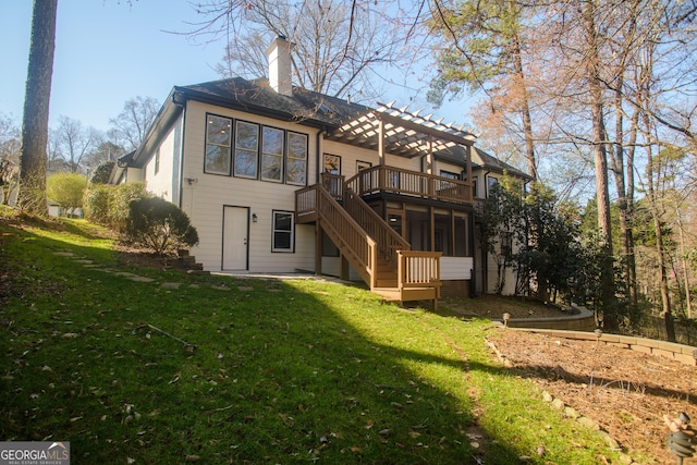 rear view of property featuring stairway, a chimney, a yard, and a deck