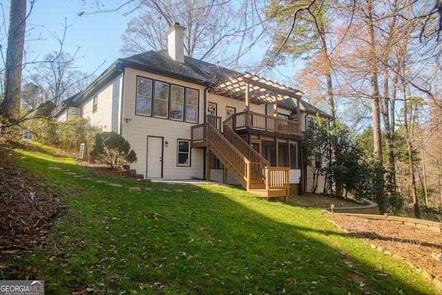 rear view of property with stairway, a yard, a sunroom, a wooden deck, and a chimney