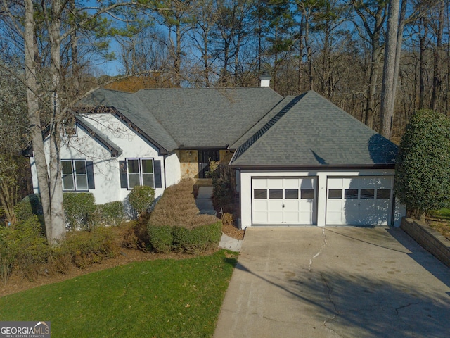 ranch-style home featuring a chimney, stucco siding, and a shingled roof