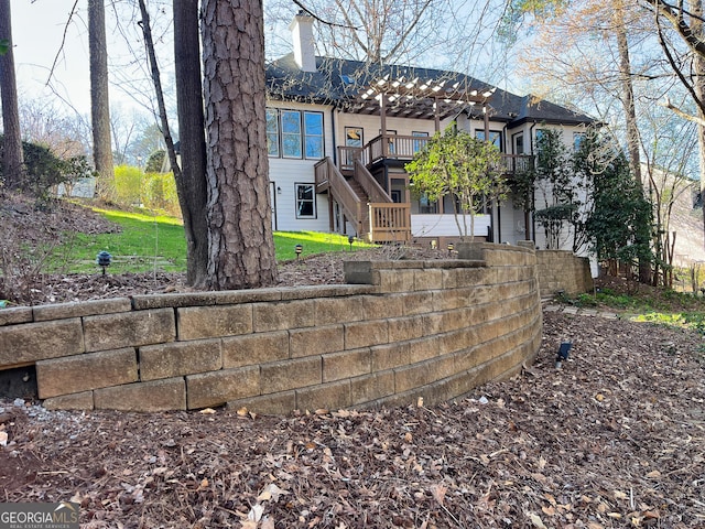 back of property with stairway and a chimney