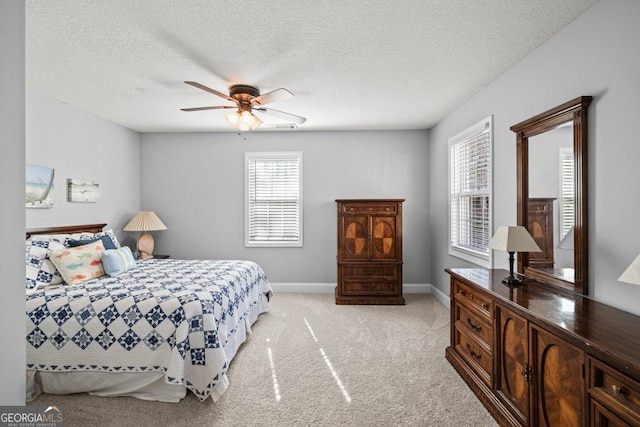 bedroom with baseboards, ceiling fan, multiple windows, and light colored carpet