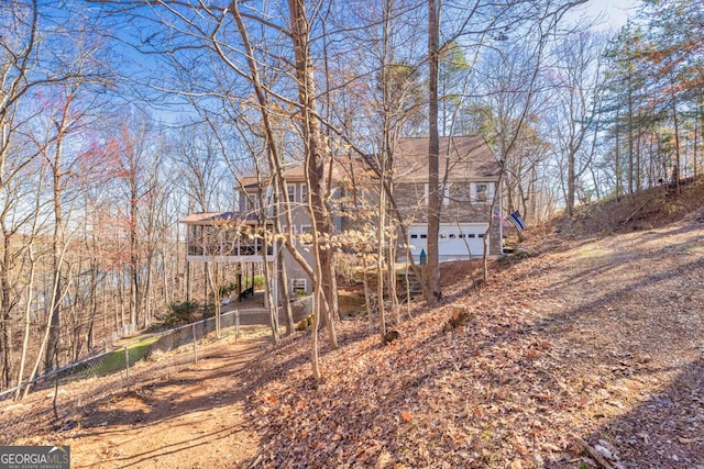 back of house featuring a garage and fence