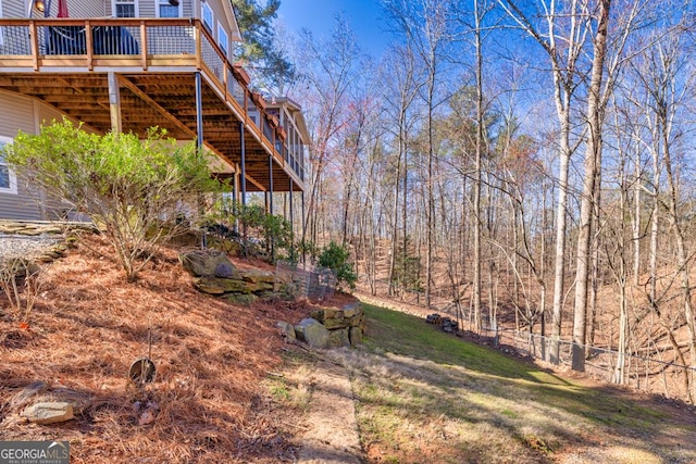 view of yard featuring a wooden deck and stairs