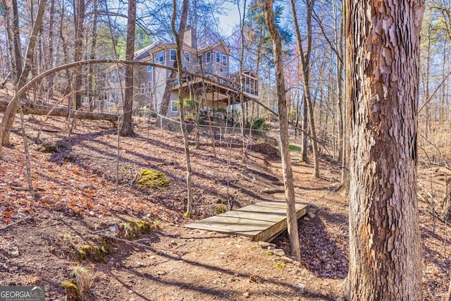 view of yard with stairs and a wooden deck