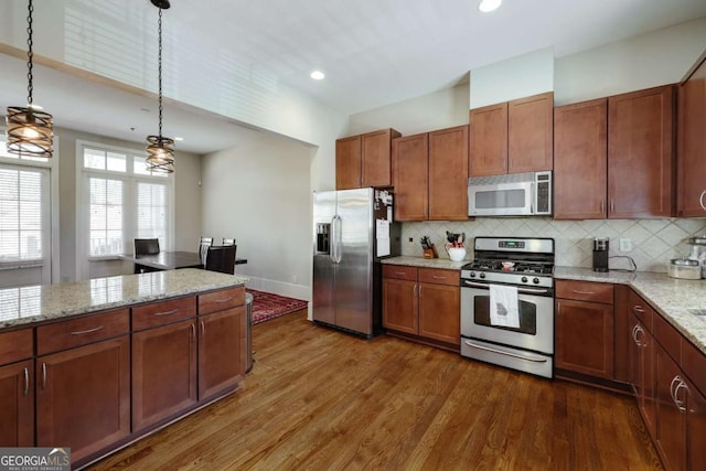 310 Research Dr Unit 303, Athens, GA 30605 - kitchen with stainless steel appliances, dark wood finished floors, tasteful backsplash, hanging light fixtures, and recessed lighting