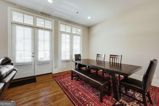 dining space featuring wood finished floors and recessed lighting