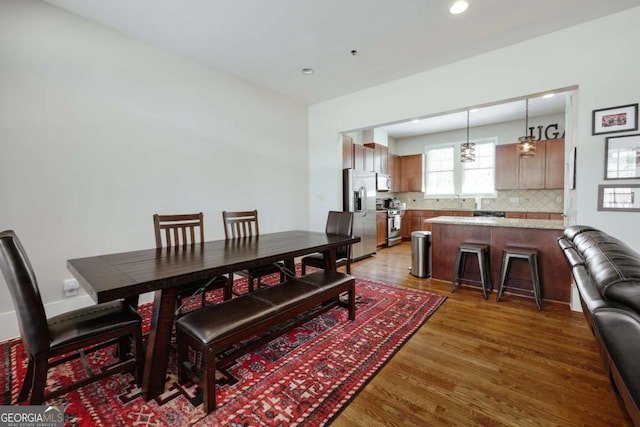 dining space featuring recessed lighting and light wood-style flooring