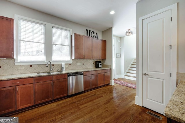 310 Research Dr Unit 303, Athens, GA 30605 - kitchen featuring stainless steel dishwasher, a sink, tasteful backsplash, dark wood-type flooring, and light stone counters